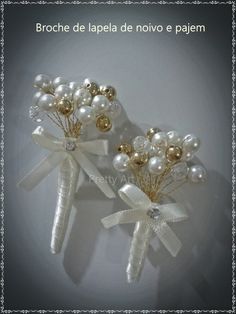 two white hair clips with pearls and bows on them, one is for the bride