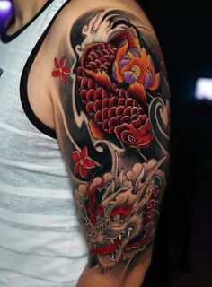 a man with a dragon and flower tattoo on his arm