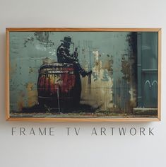 a man sitting on top of a barrel in front of a sign that says frame tv artwork