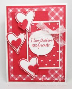 a red and white card with hearts on it, saying i love that we are friends