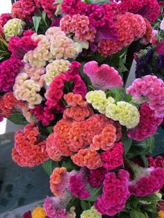 many different colored flowers are in the vase