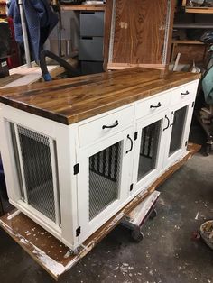 a kitchen island made out of an old cabinet with doors and drawers on the top