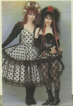 two women dressed in costumes posing for a photo