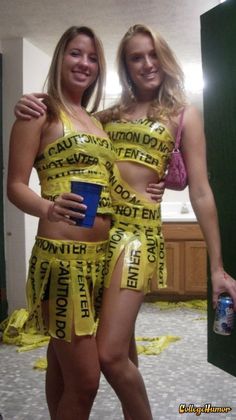 two women dressed up in yellow clothing posing for the camera with one holding a blue cup