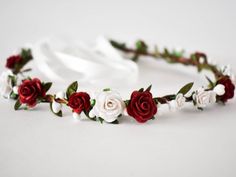 Gorgeous deep red and white handmade roses are delicately scattered about this petite rustic crown. The flexible base is covered in natural bark and intertwined with white berry vines and optional green leaf ribbons Perfect for a winter wedding, this crown would make a lovely accessory for any bride, bridesmaid, or flower girl. The colors photograph beautifully and would look equally as stunning in Holiday, graduation, engagement, maternity and infant photo sessions. The crown is adjustable as i Red Head Band, White Floral Crown, White Flower Crown, Flower Crown Bride, Red And White Weddings, Rose Flower Crown, Red Bouquet Wedding, Red Bouquet, Flower Girl Crown