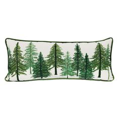 a green and white pillow with pine trees on the front, sitting in front of a white background