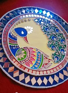 a decorative plate with a peacock on it