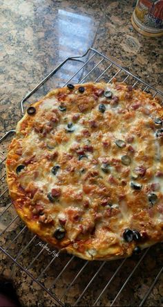 a pizza sitting on top of a metal rack