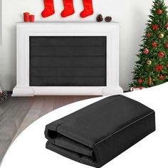 a christmas tree with stockings hanging on it and a black ottoman cover in the foreground