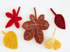 crocheted autumn leaves arranged on white surface