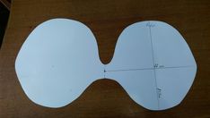 a piece of paper cut out to look like an eyeglasses with measurements on it