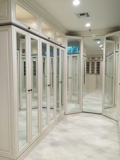 an empty room with mirrored doors and white walls