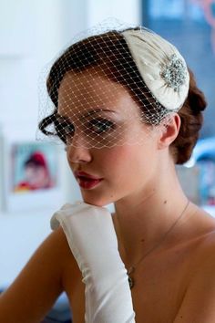 a woman with a veil and gloves on her head