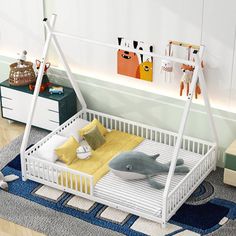 a white baby crib with a stuffed whale in the middle and other toys on the floor