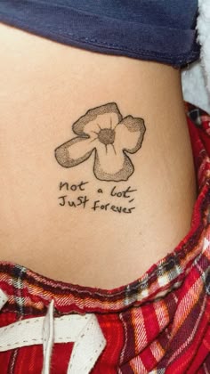 a woman with a tattoo on her stomach saying not a lot just flowers