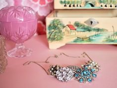 an assortment of jewelry on a pink table