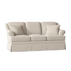 a white couch with two pillows on it