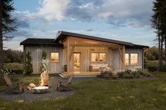 a small wooden cabin sitting on top of a lush green field