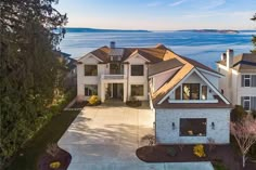 this is an aerial view of a house with the ocean in the backround