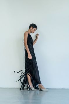 This enchanting Teatralna Black dress is a vision of grace, fashioned entirely from 100% silk. Its backless allure adds a hint of sensuality, while the dual layers of silk add depth and texture. The distinctive feature lies in the top layer, composed of vertical stripes that elegantly run longer than the bottom layer, creating a captivating play of length and movement. The arrangement of these strips imparts a unique, modern charm to the gown, making it a standout choice for those seeking a blen Strips Dress, Gown Making, Black Pure, Stripped Dress, Timeless Luxury, Under Dress, Vertical Stripes, Dress 100, Dresses Xs