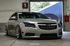 a silver car is parked in a garage