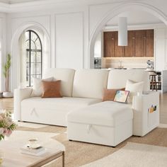 a living room filled with white furniture and lots of windows in it's walls