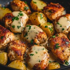 chicken and potatoes with gravy in a skillet, ready to be eaten