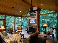 a living room filled with furniture and a flat screen tv on top of a wooden ceiling