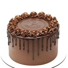 a chocolate cake with chocolate icing and flowers on the top is ready to be eaten