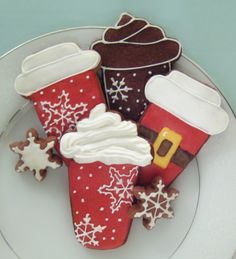 decorated cookies on a plate with frosting and icing in the shape of santa's boots