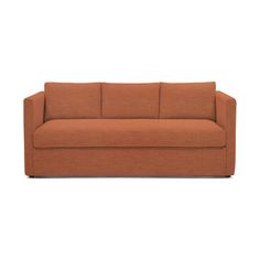 an orange couch sitting on top of a white floor