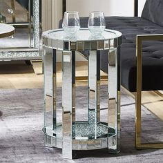 two wine glasses sitting on top of a glass table