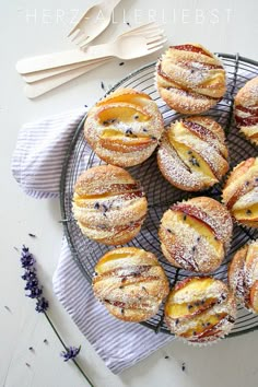 there are many pastries that are on the wire rack with utensils next to them