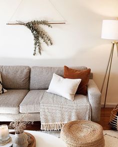 a living room filled with furniture and pillows on top of a white carpeted floor