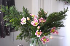 a vase filled with pink flowers on top of a table