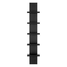 a tall black shelf sitting on top of a white wall