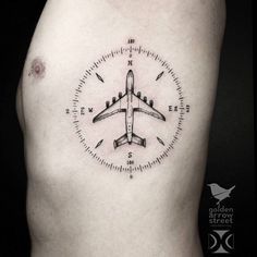 an airplane tattoo on the side of a man's right arm and chest is shown