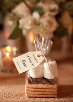 some cookies are wrapped in clear cellophane and sitting on a table with candles