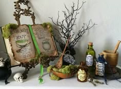 a table topped with lots of different items and decor on top of a white cloth covered table