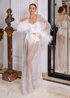 Born to shine! This robe will make you feel like a queen. Luxurious shiny sequined lace embroidered with pearls of different sizes. The sleeves of the robe are decorated with flowers made of natural feathers, which we create by hand according to our design. The robe has a soft mesh lining. The image is complemented by a thin belt, which is also decorated with natural feathers. This piece fits true to our size chart. If you're not sure which size will fit you perfectly, just choose your regular size to place an order. After placing an order, one of our team members will reach out to you by message or email to get all your measurements, height, and the date of your wedding, to create and deliver your perfect robe in time. The bodysuit is not included. All our items are 100% handmade and cust Born To Shine, Team Members, Bridesmaid Robes, Bridal Robes, To Shine, Couture Collection, Petite Size, Bridal Accessories, Summer Sale