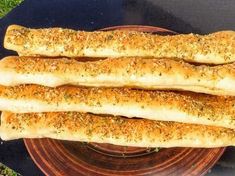 three long breadsticks sitting on top of a plate