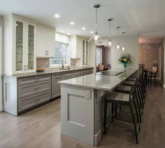 a large kitchen with an island in the middle and lots of counter space on one side