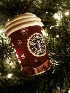 a starbucks cup ornament hanging from a christmas tree