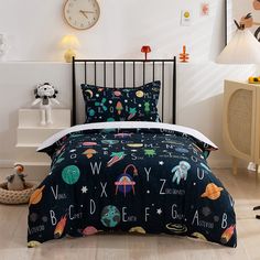 a bed with space themed comforters and pillows