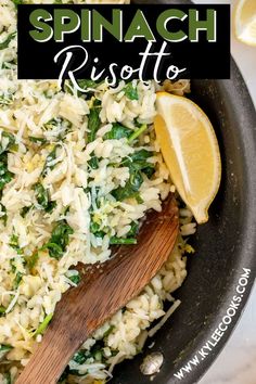 spinach risotto in a skillet with lemon wedges on the side