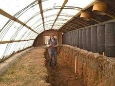 a man standing next to a pile of hay in a tunnel filled with lots of dry grass