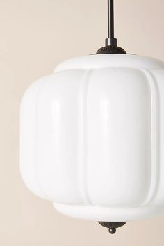 a white light fixture hanging from a ceiling