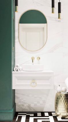 a bathroom with green and white walls, black and white checkered flooring and gold accents