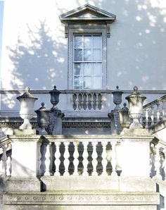 a white building with an ornate balcony and balconies