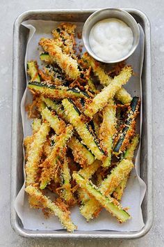 fried zucchini fries on a tray with ranch dressing